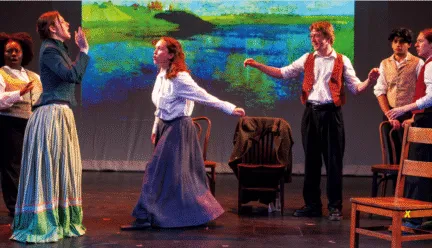 people on stage, chairs near 